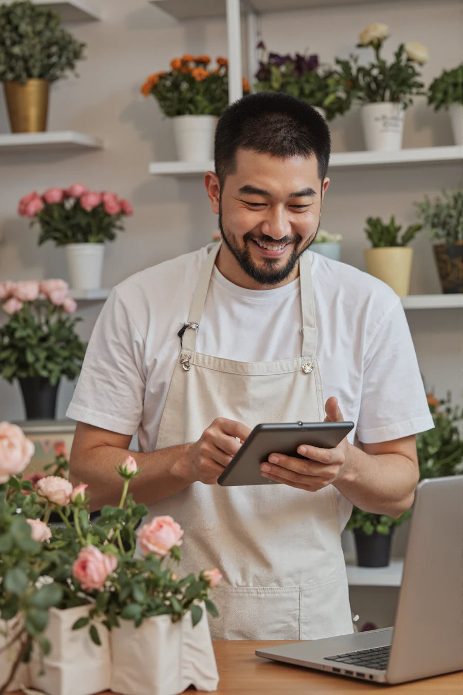 A florist taking stock on a tablet